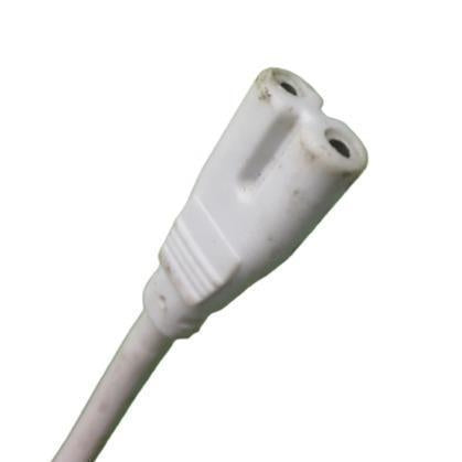 White two-prong power cord connector with visible dirt on plastic casing