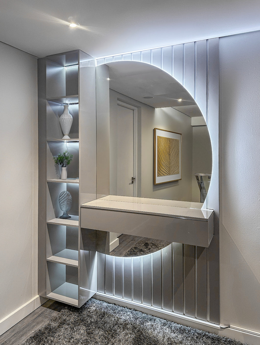 Modern interior design with a round mirror with back lighting and shelves in a room.